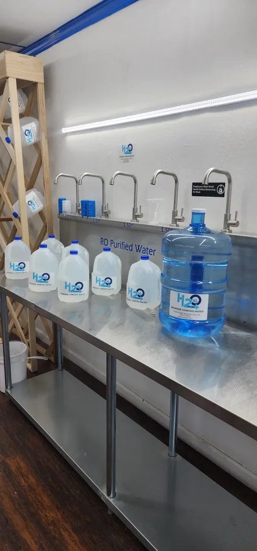 Refill station with H2O to Go jugs lined up and ready